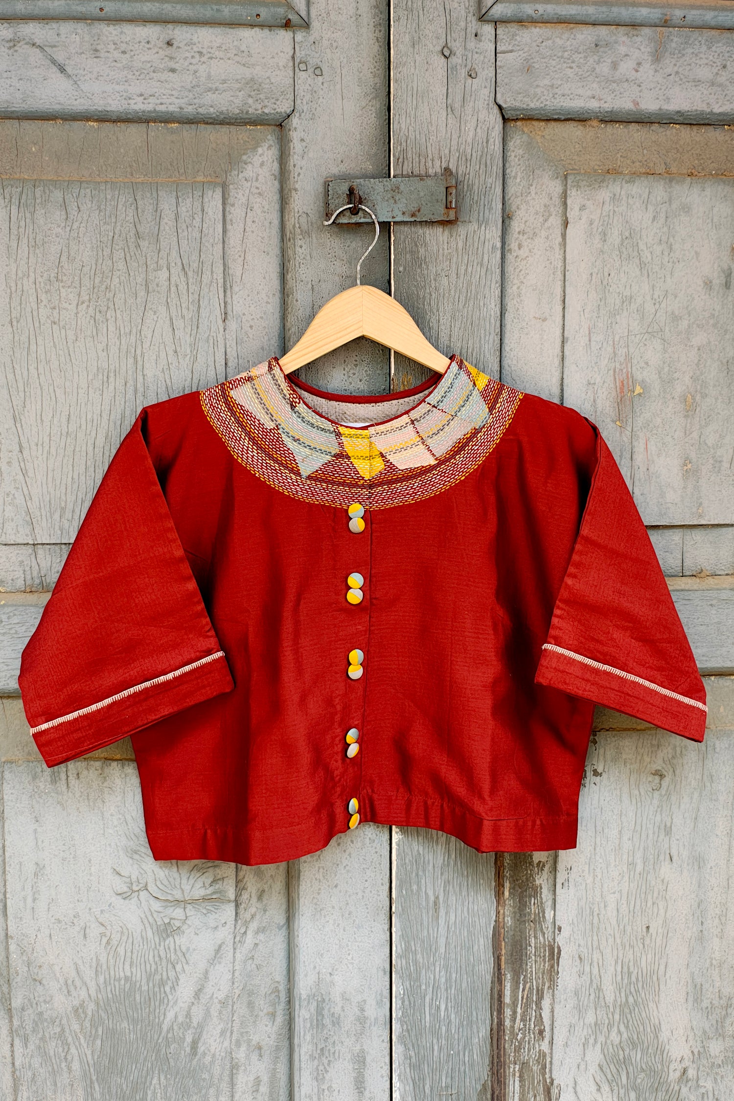 Chanderi Rust crop top with sujani work on neck line.